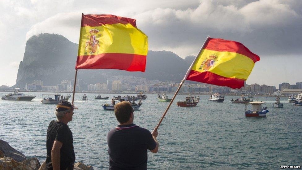 Spanish fishermen wave Spanish flags during a protest in the bay of Algeciras