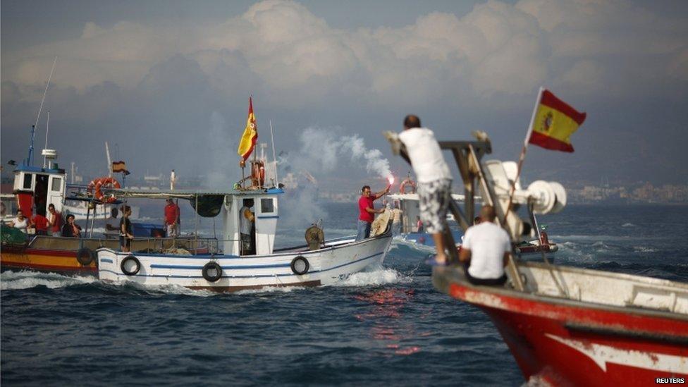 Leoncio Fernandez, head of the La Linea fishermen, held a red flare to mark the end of the demonstration.