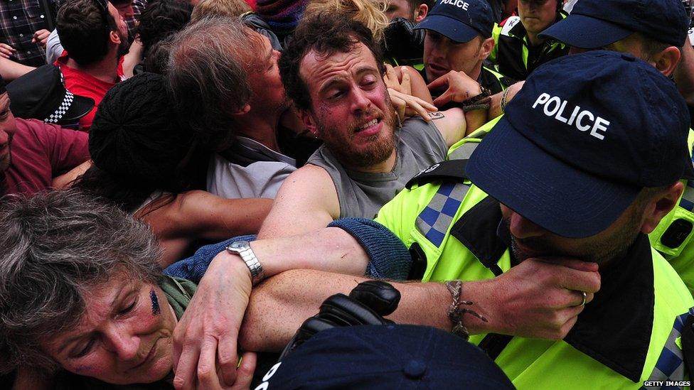 Police tussling with several protesters