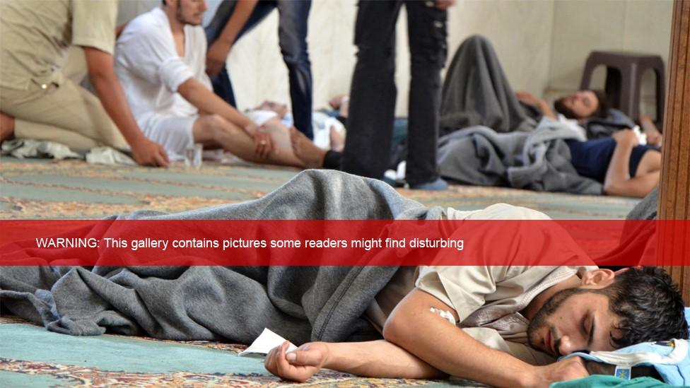 A man, who Syrian opposition activists say survived a chemical weapon attack, rests in a mosque in Douma, Damascus (21 August 2013)