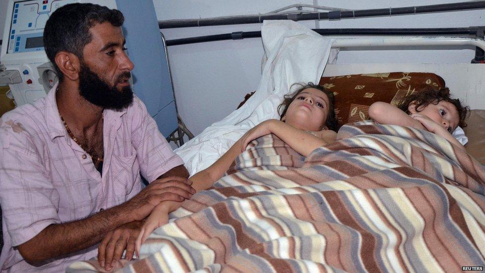 Two girls, whom Syrian opposition activists say survived a chemical weapon attack, at a hospital in Douma, Damascus (21 August 2013)