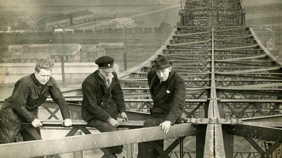 Workers scaling the bridge in the 1950s