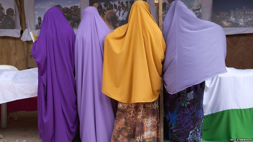 Girls at the book fair viewing a photo exhibition by Ethiopia-based photojournalist Petterik Wiggers - Hargeisa, Somaliland