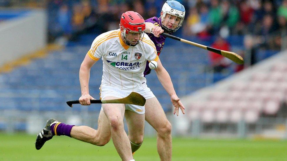 Conor McCann of Antrim is challenged by Wexford's Shane O'Gorman during the Under-21 semi-final at Semple Stadium