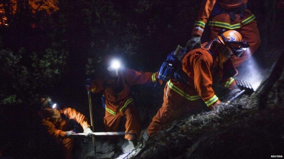 Firefighters work on steep slopes through the night, combating California's Rim Fire on 25 August 2013