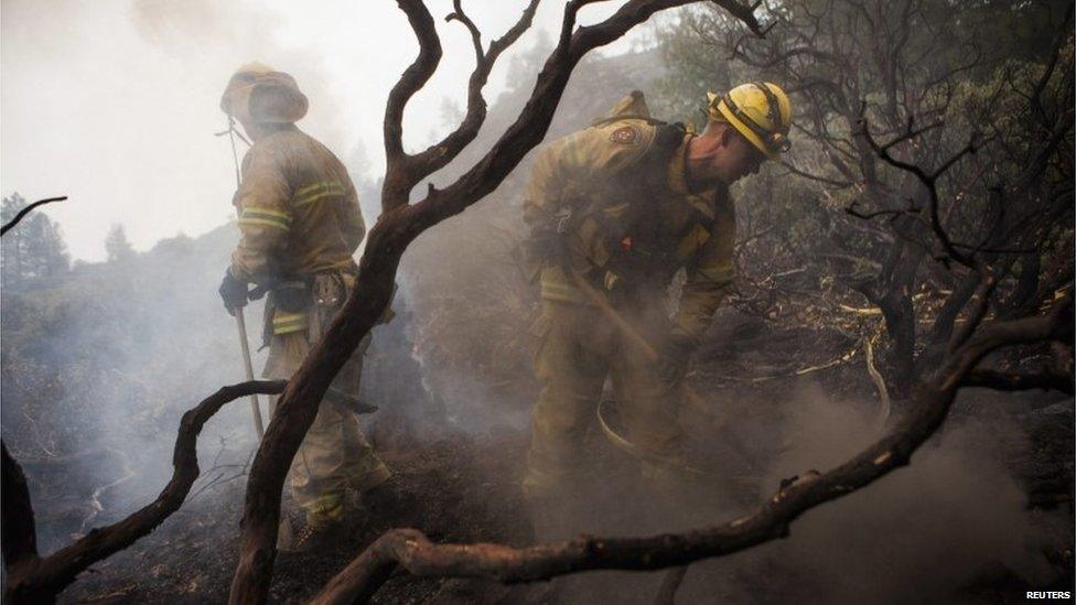 Firefighters at work surrounded by charred debris near Yosemite National Park in California on 24 August 2013