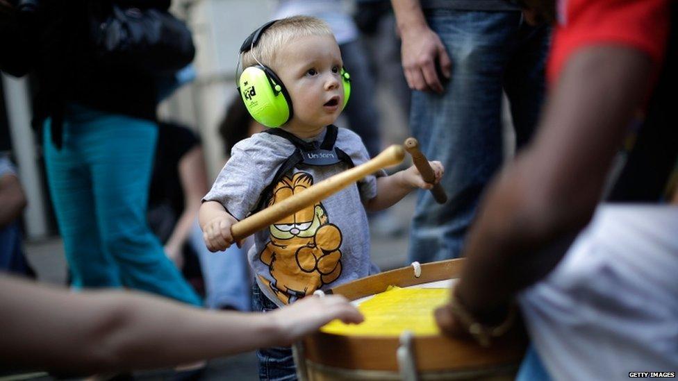 Child wears ear defenders at the Notting Hill Carnival