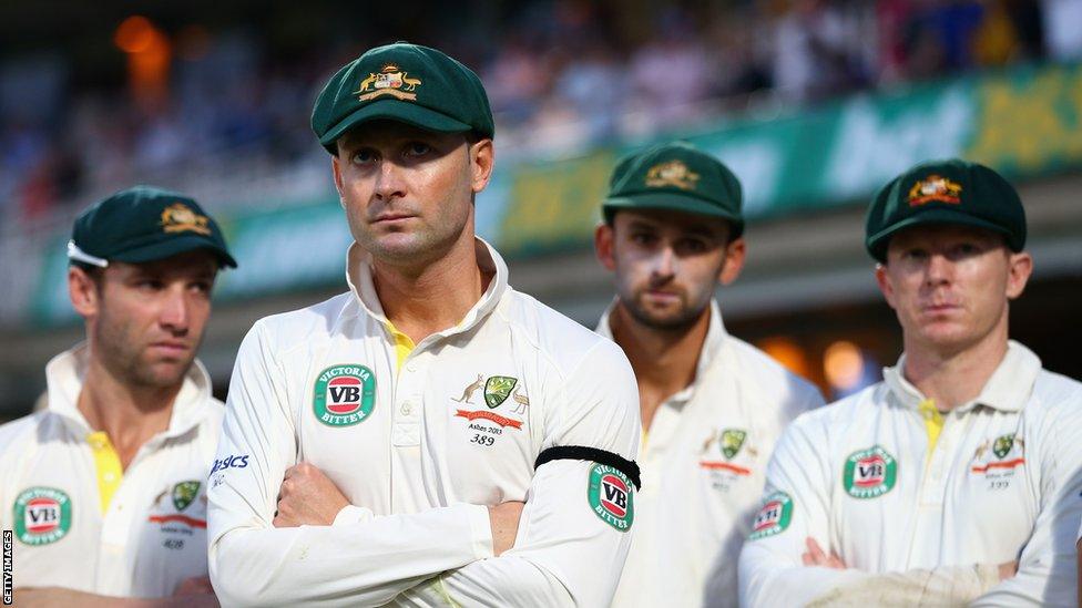 Michael Clarke, who captained Australia's heaviest Ashes series defeat since 1978-79, looks on at the celebrations glumly.