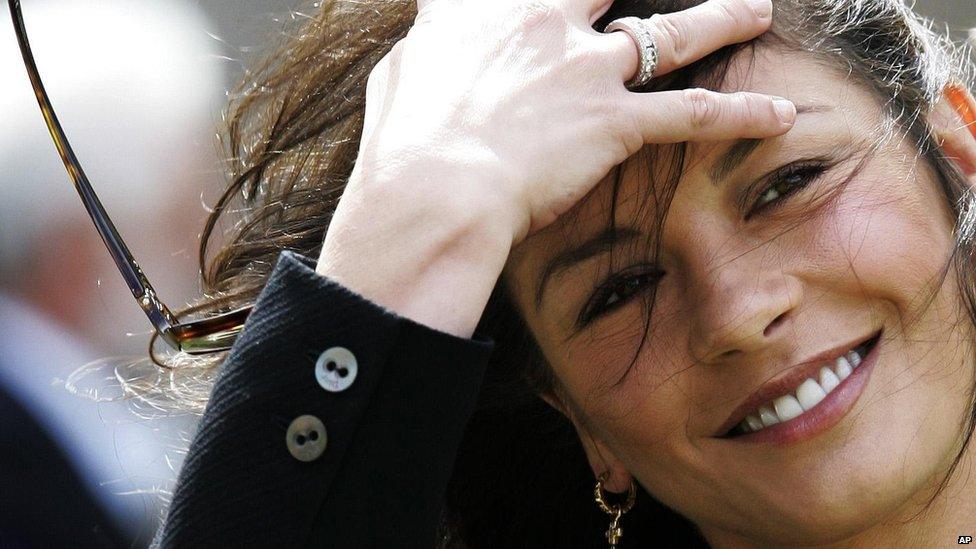 Actress Catherine Zeta Jones gets windswept outside Younger Hall in St Andrews, Scotland, Wednesday, June 21, 2006, after her husband Michael Douglas collected an honorary degree from St. Andrew's University.