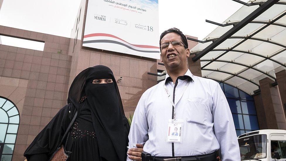 Ahmed Ateeq, a professor at Sanaa University and a member of Yemen's National Dialogue Conference, is guided by his wife Masouda.