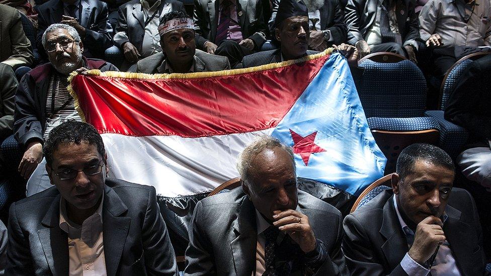 NDC members hold up the flag of the former People’s Democratic Republic of Yemen, which is now synonymous with the Southern Movement, a coalition of groups seeking either social and political parity with – or outright secession from – Yemen’s north