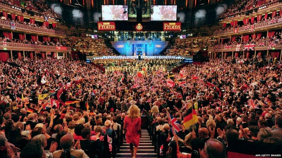 People wave flags at the Royal Albert Hall in west London on September 7, 2013 during the last night of the Proms