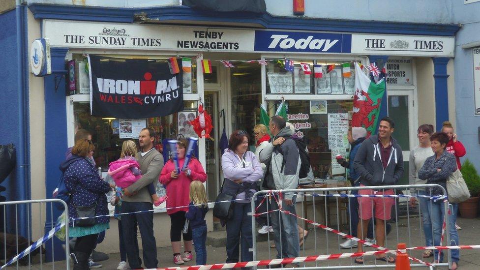 Crowds outside a newsagents in Tenby