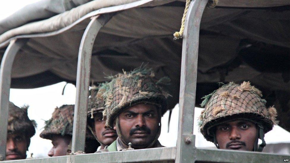 Indian soldiers look on from a military vehicle during a patrol following communal riots between Muslims and Hindus in Muzaffarnagar, India's Uttar Pradesh state, on September 9, 2013.