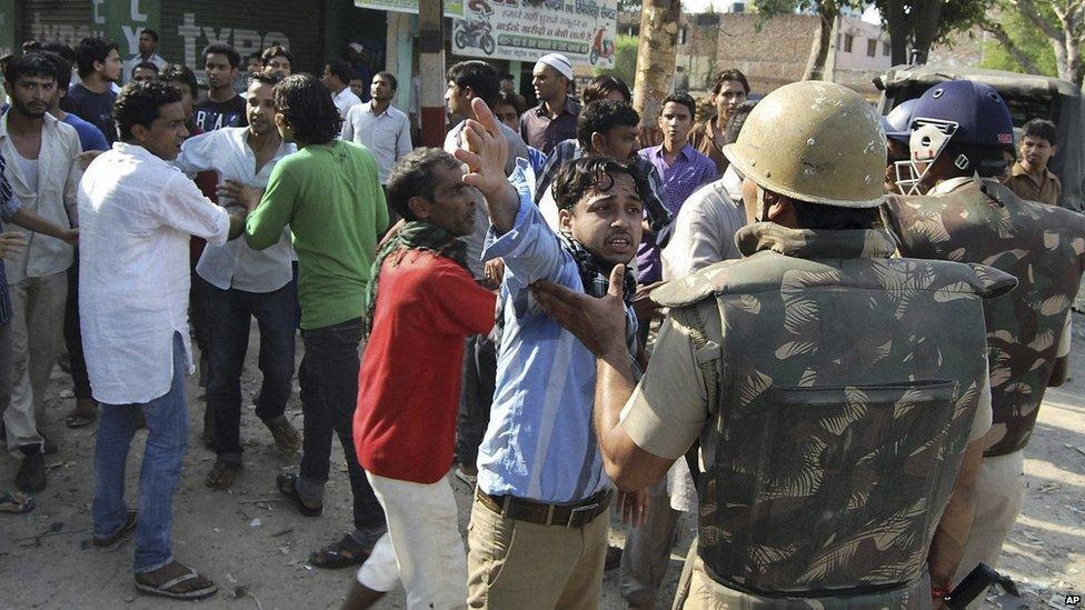 In this photo, people argue with Indian policemen during curfew hours following riots and clashes between two communities in Muzaffarnagar in the Indian state of Uttar Pradesh.