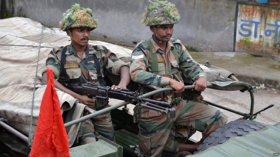 Indian soldiers keep watch during a patrol following communal riots between Muslims and Hindus in Muzaffarnagar, India"s Uttar Pradesh state, on September 9, 2013