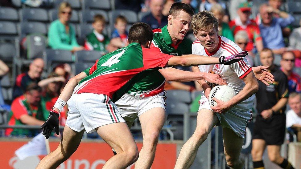 David Kenny and Diarmuid O'Connor of Mayo close in on Tyrone half-back Padraig McGirr