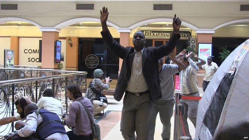 Shoppers raise their arms as they are evacuated from the Westgate mall (21 Sept. 2013) (screengrab)