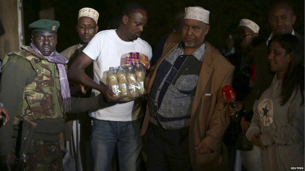 Members of Nairobi's Somali community deliver food and drinks to soldiers and security personnel near the shopping centre as darkness falls on Monday September 23.