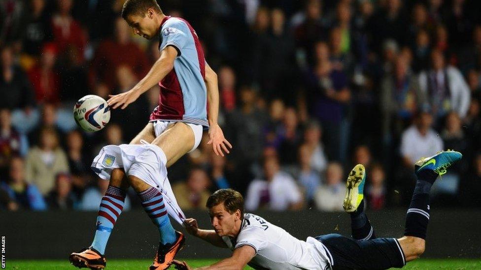 Jan Vertonghen of Tottenham Hotspur hangs on to the shorts of Nicklas Helenius of Aston Villa during the Capital One Cup third round match between Aston Villa and Tottenham Hotspur at Villa Park on September 24 2013