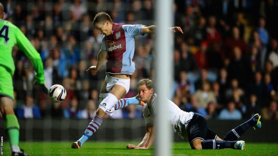 Jan Vertonghen of Tottenham Hotspur hangs on to the shorts of Nicklas Helenius of Aston Villa during the Capital One Cup third round match between Aston Villa and Tottenham Hotspur at Villa Park