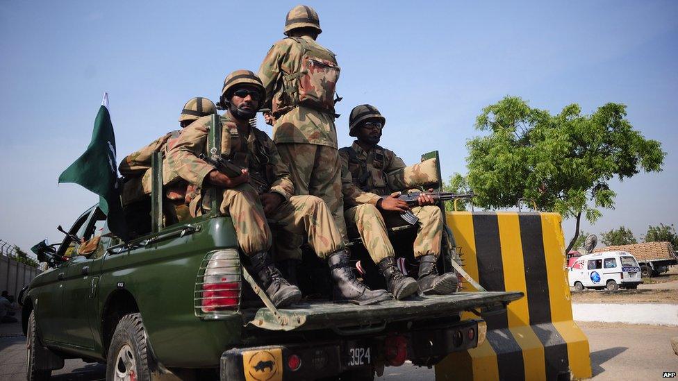 Pakistani troops ride to areas affected by an earthquake in military trucks in Karachi on September 25, 2013.