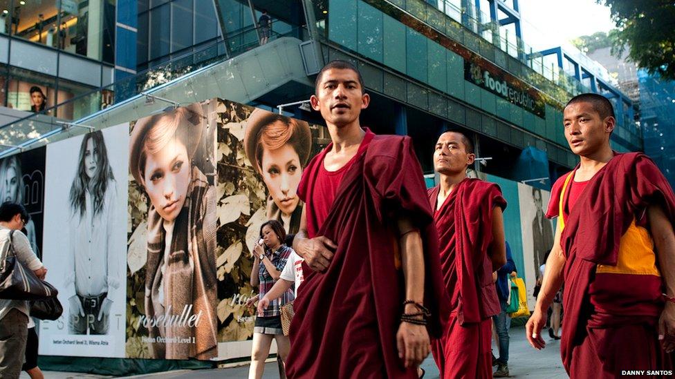 Monks walking along Singapore's Orchard Road, a shopping haven.