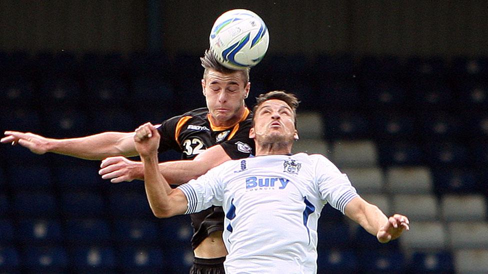 Andrew Hughes of Newport beats Bury's Marco Navas in the air