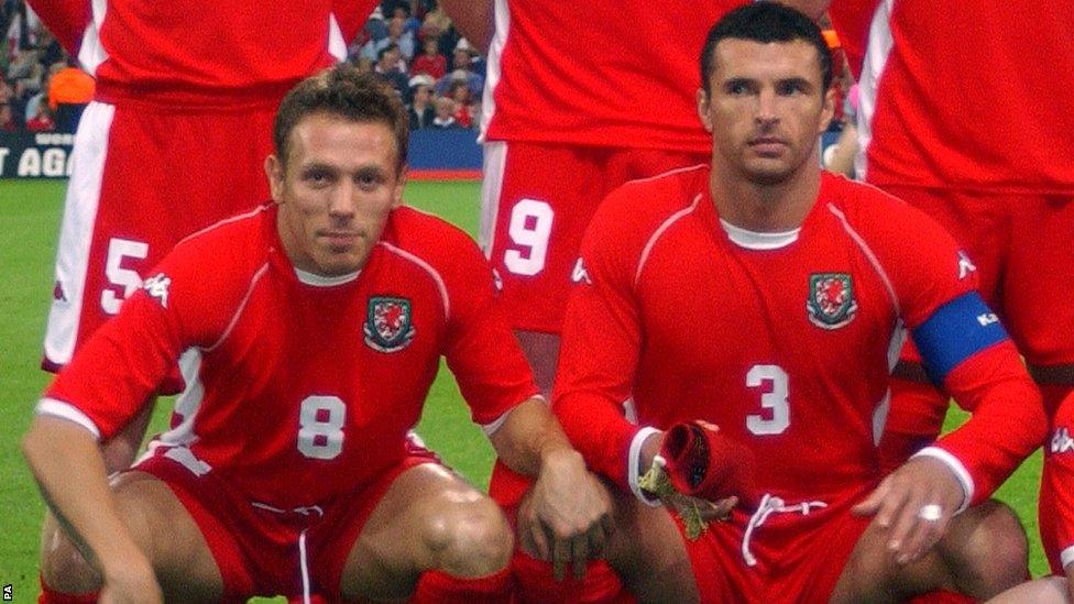 Bellamy lines up with team-mate and close friend Gary Speed prior to Wales' Euro 2004 qualifier against Italy at the Millennium Stadium in October 2002