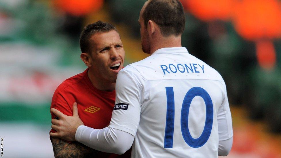 Wayne Rooney restrains Bellamy as Wales lose 2-0 to England in a Euro 2012 qualifier in Cardiff