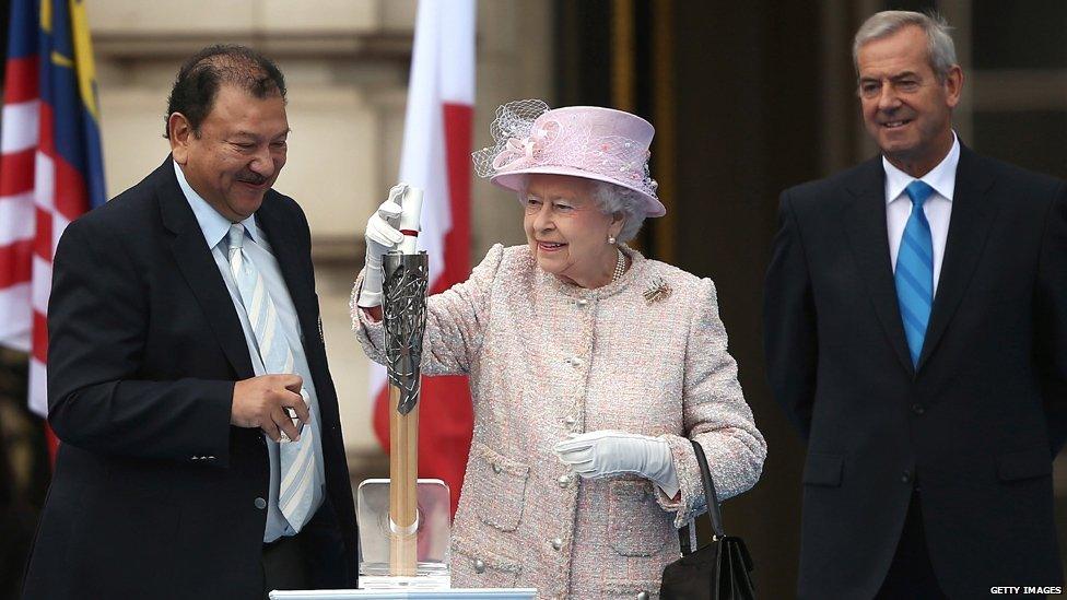 The Queen places her message inside the baton