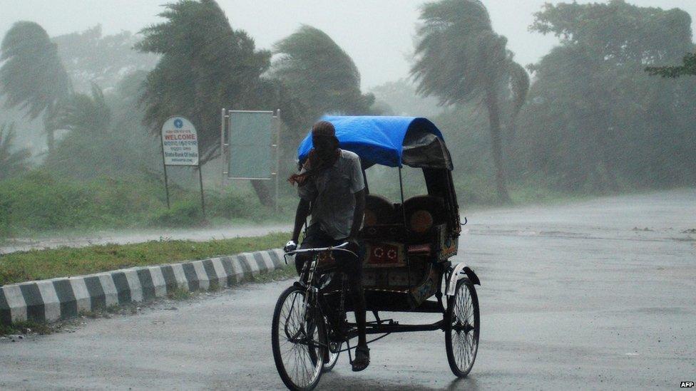 A rickshaw man bikes through heavy rain in Berhampur, about 180 kilometres south from eastern city Bhubaneswar