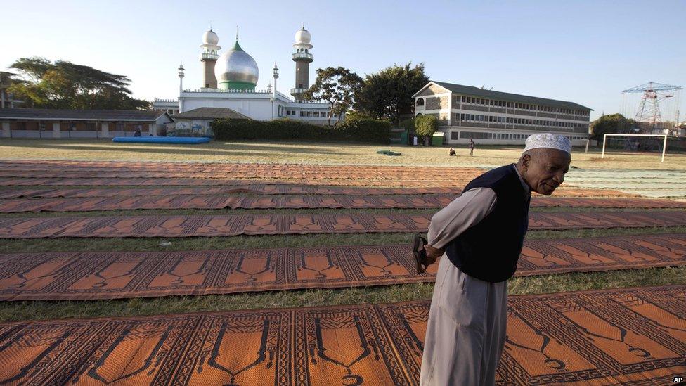 A mosque attendant in Nairobi, Kenya waits for Muslims to arrive for prayers to mark the end of the Eid festival