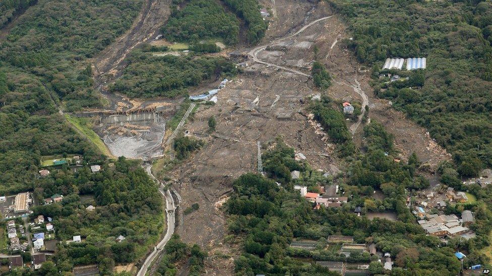 Houses in a residential area in Oshima are buried by mudslides after a powerful typhoon hit Izu Oshima island on 16 October 2013