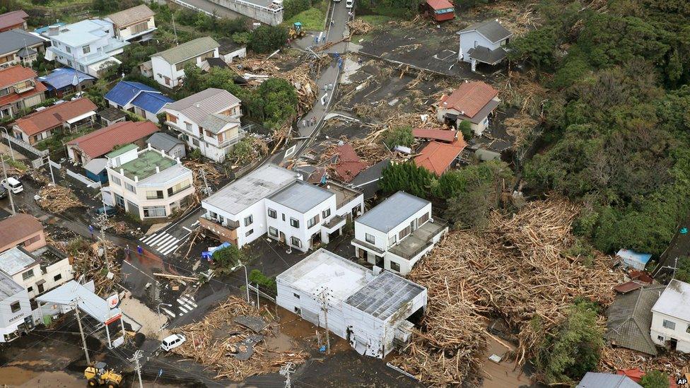Several houses in a residential area are covered by debris from mudslides after a powerful typhoon hit Izu Oshima island on 16 October 2013