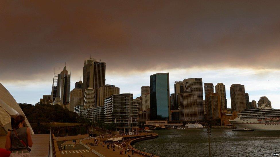 Smoke and ash from wildfires burning across the state of New South Wales blankets the Sydney city skyline