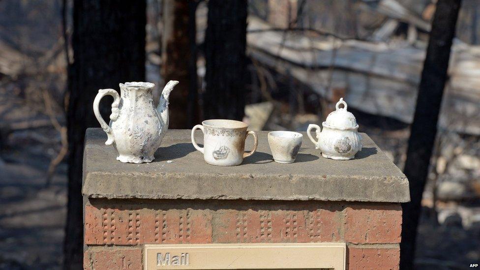 Saved crockery sits on the letterbox at the front of a house destroyed by bushfires in Winmalee in Sydney's Blue Mountains on 18 October 2013