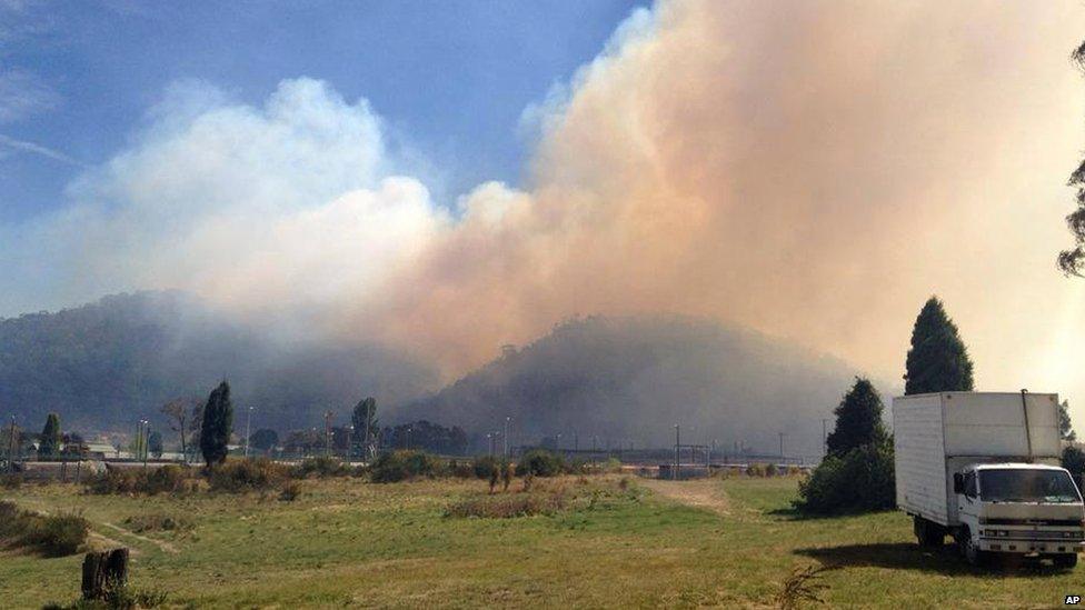 In this photo provided by the New South Wales Rural Fire Service, smoke rises from a fire near Lithgow, west of Sydney, on 17 October 2013