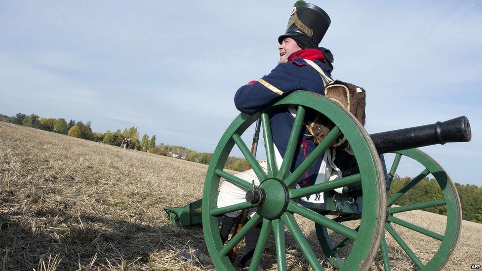Re-enactor dressed as French soldier sits on artillery piece, Leipzig (20 October)
