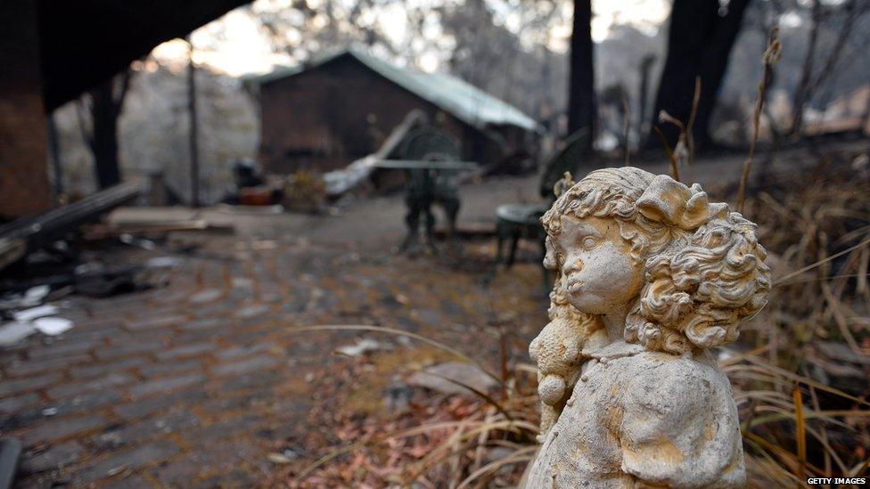 Statue stands outside a burnt out home in Winmalee. 22 Oct 2013