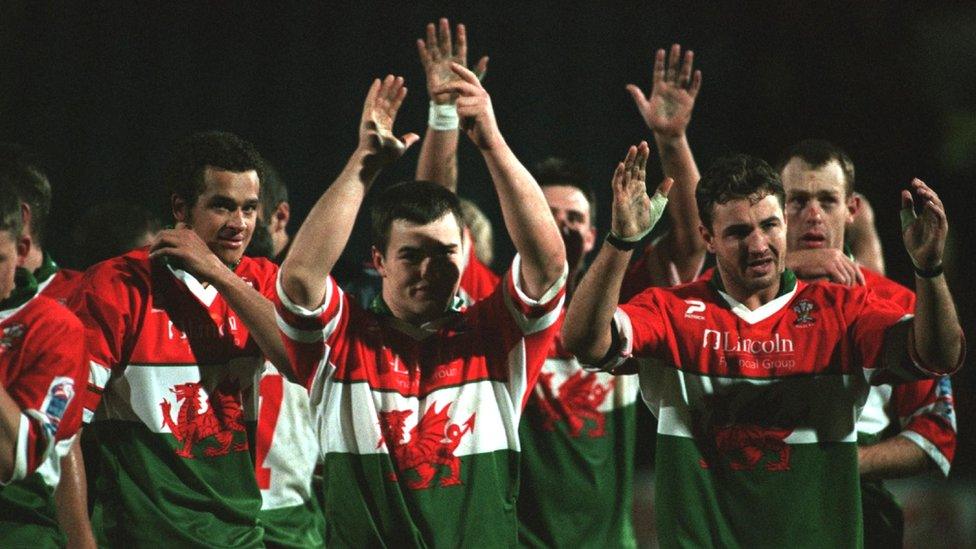 Iestyn Harris leads Wales in applauding their fans during the 2000 Rugby League World Cup