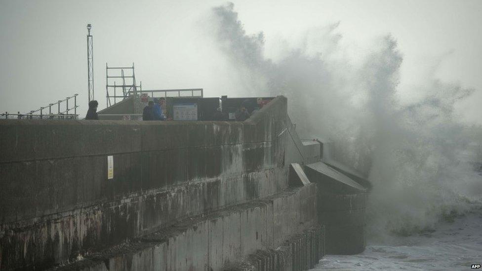 Large waves crash against the walls of Brighton Marina