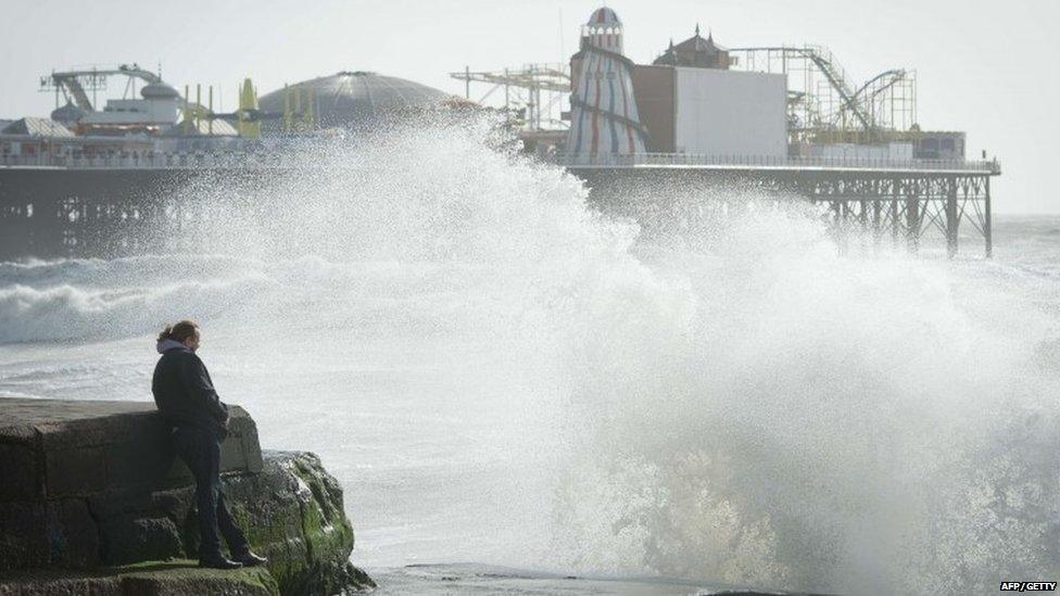 Large waves break against barriers on the seafront in Brighton