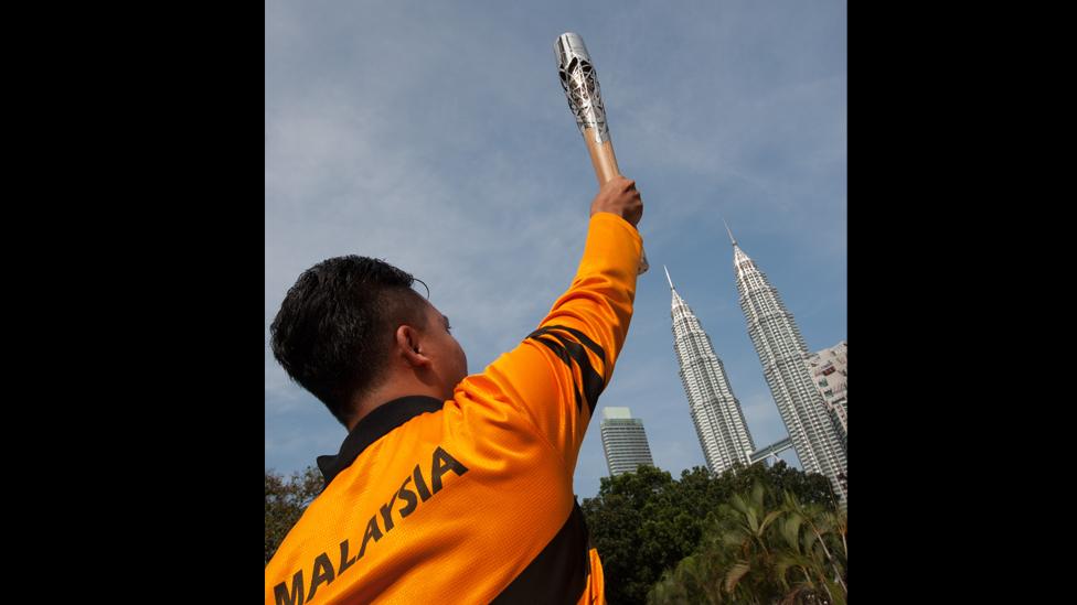 The Queen's Baton, with PETRONAS Towers in the background, in Kuala Lumpur, Malaysia.