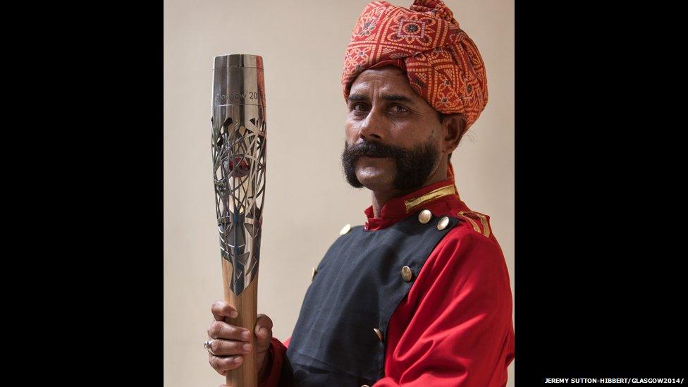 The Queen's Baton is held by an Indian hotel concierge in Agra, India.