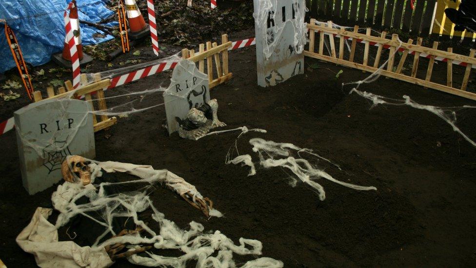Three graves with skeletons in it
