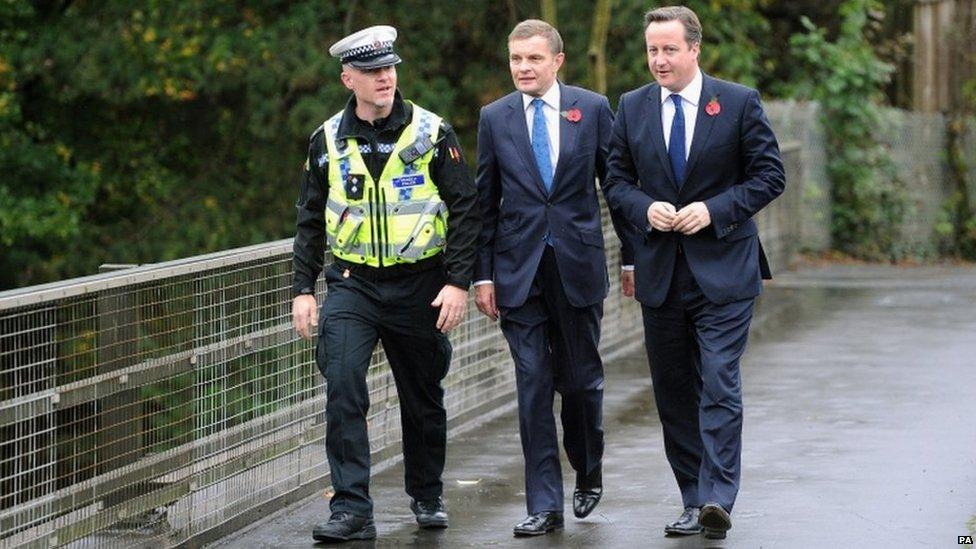 Prime Minister David Cameron speaks with Traffic Police Inspector Rob Gwynne-Thomas and Secretary of State for Wales David Jones overlooking the M4 outside Cardiff.