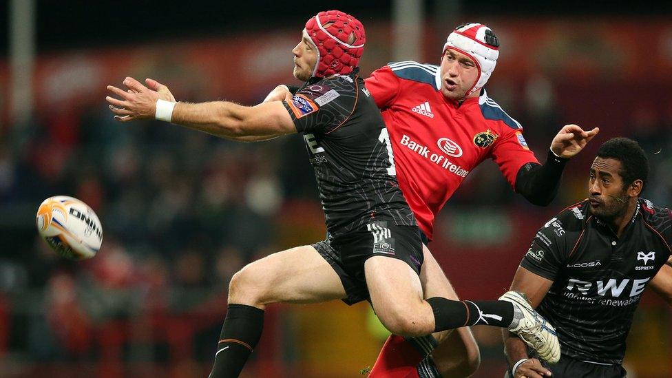 Munster's Johne Murphy tackles Richard Fussell of Ospreys
