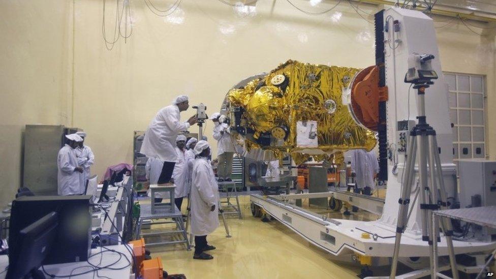 Indian scientists and engineers work with their staff on the Mars orbiter spacecraft at the satellite centre of Indian Space Research Organization (ISRO) in Bangalore