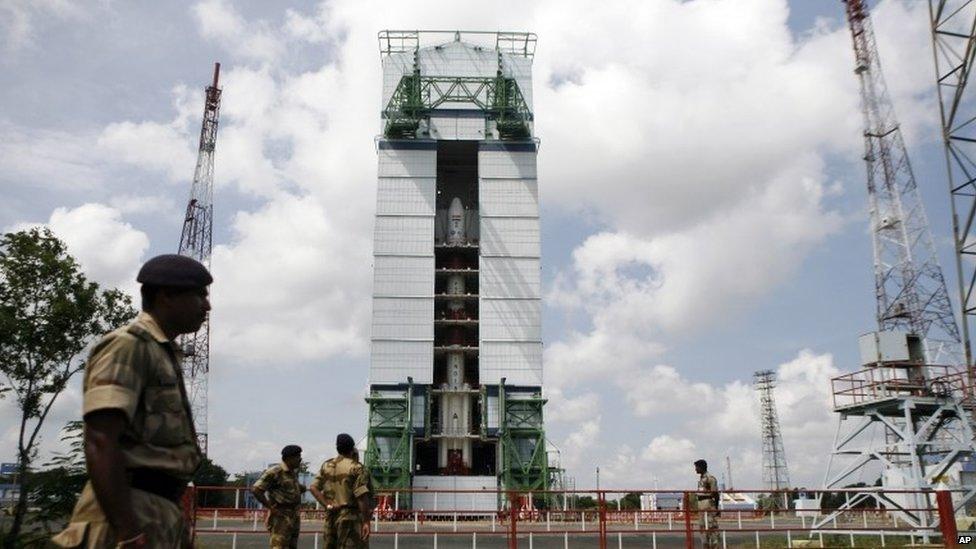 Paramilitary soldiers stand guard near the Polar Satellite Launch Vehicle (PSLV-C25) at the Satish Dhawan Space Center at Sriharikota, in the southern Indian state of Andhra Pradesh